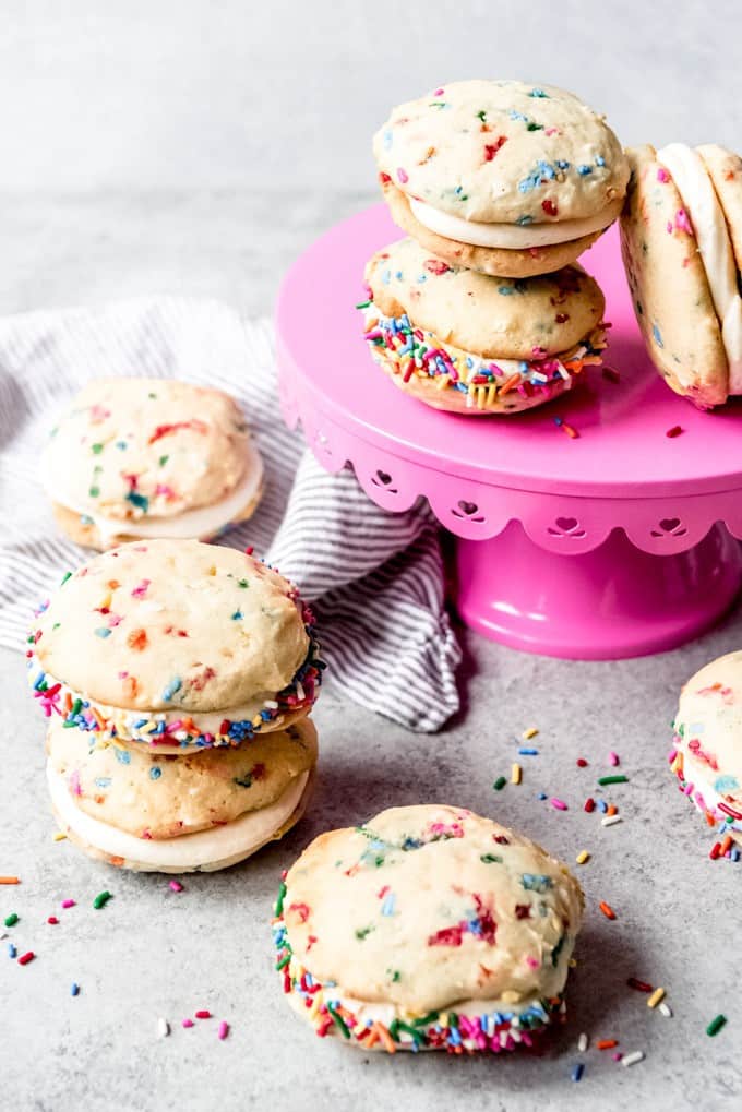 An image of confetti whoopie pies stacked on a pink cake stand.