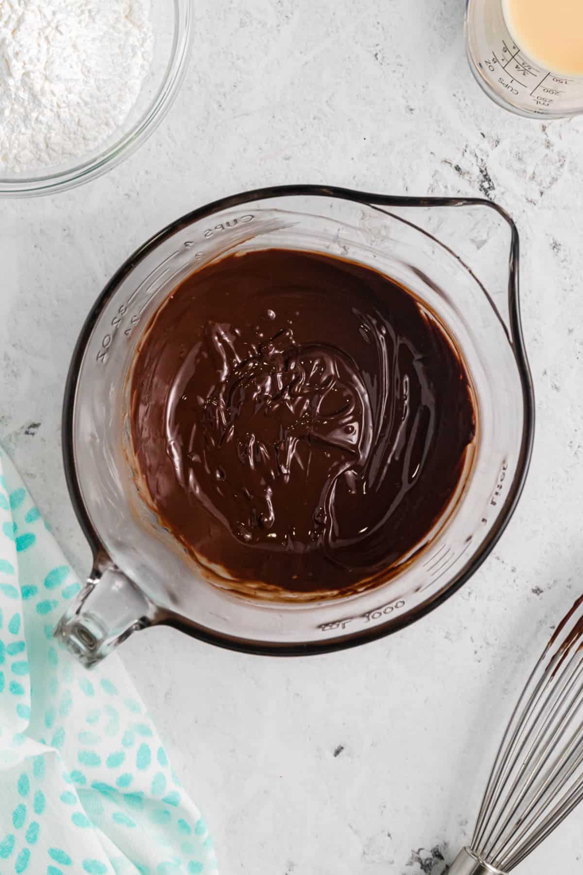 Melted chocolate and butter in a glass mixing bowl.