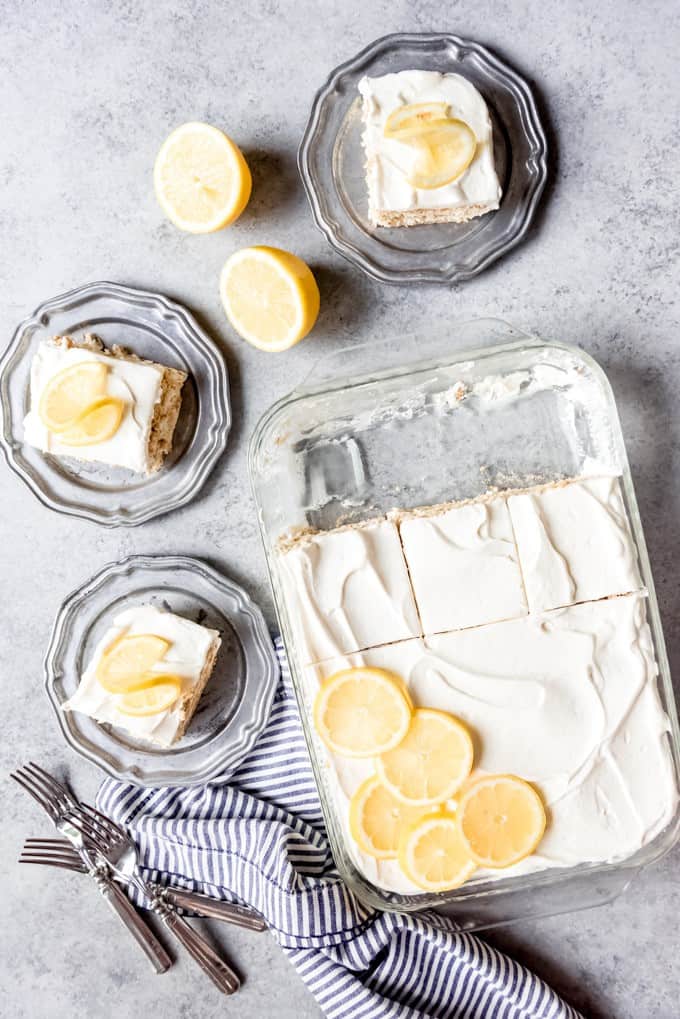 An image of of a lemon icebox cake, sliced into squares and served on dessert plates.