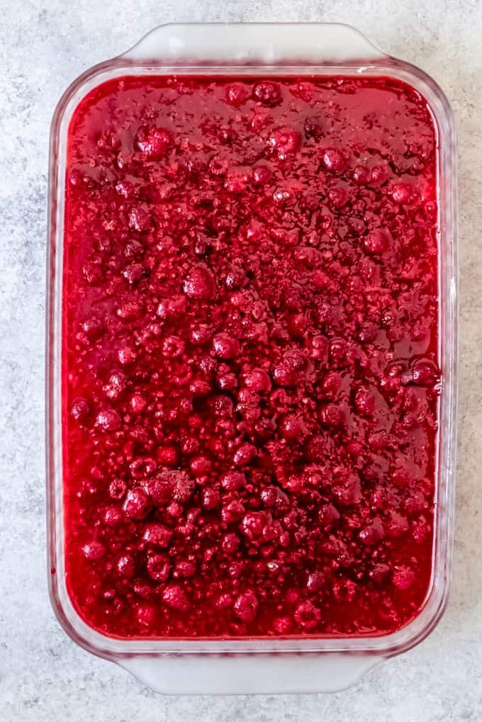 An image of the raspberry jello layer of a raspberry pretzel salad.