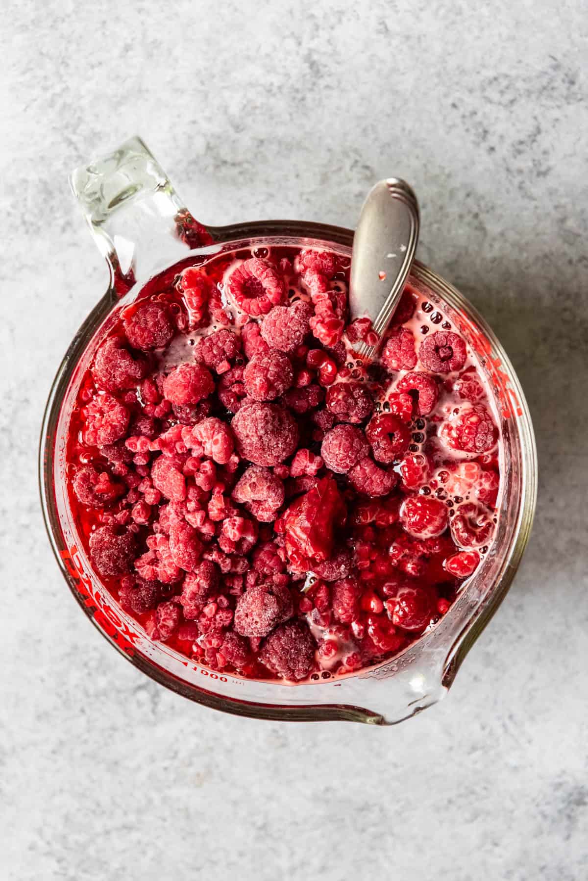 An image of frozen raspberries in jello.