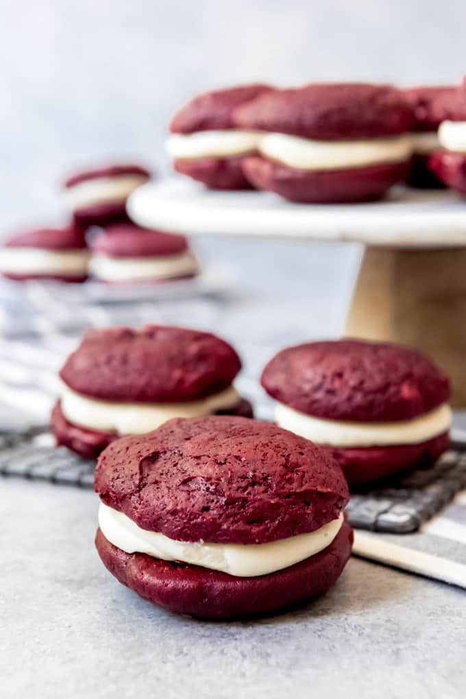 An image of soft red velvet cookies sandwiched with cream cheese frosting.