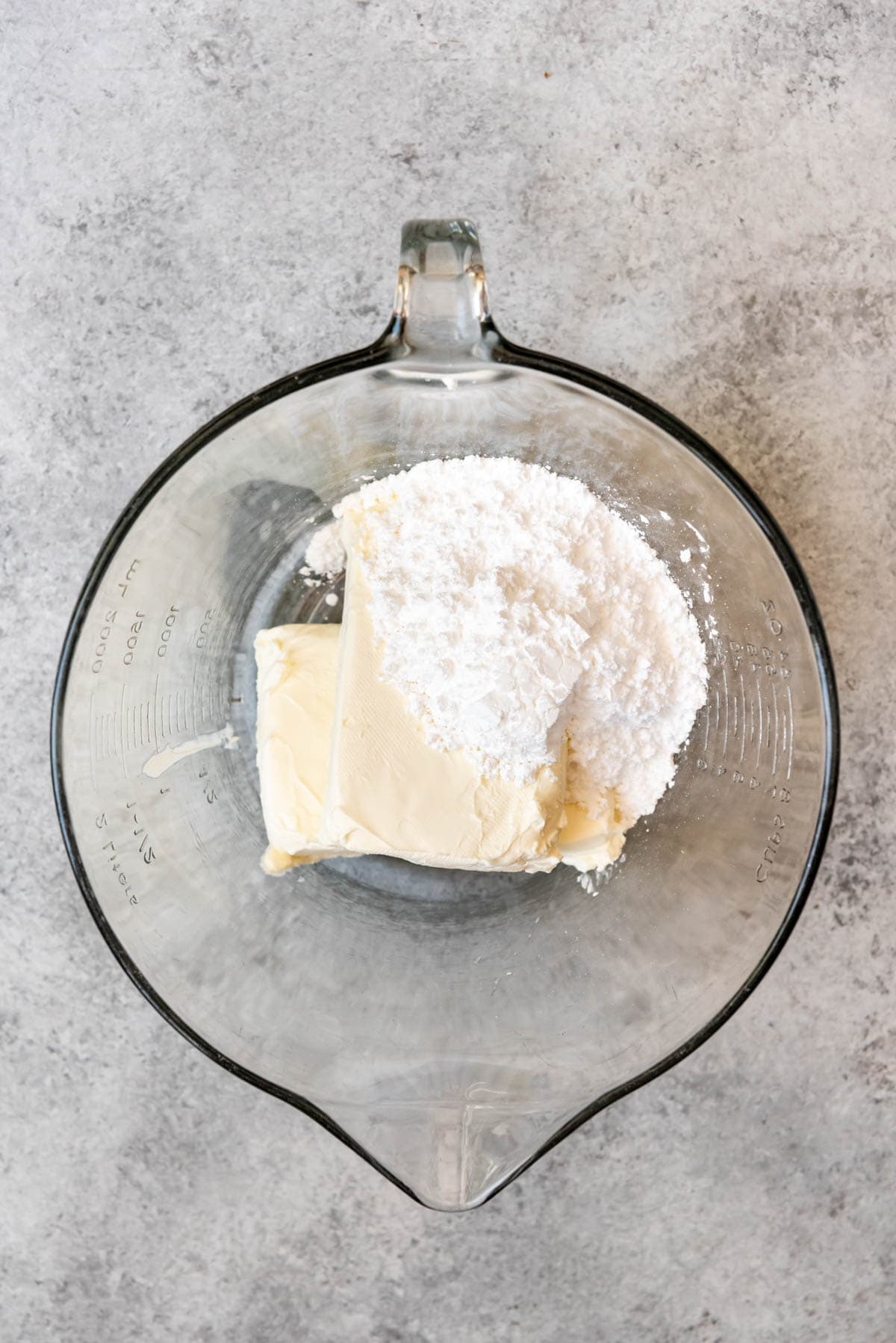 An image of cream cheese and powdered sugar in a bowl.