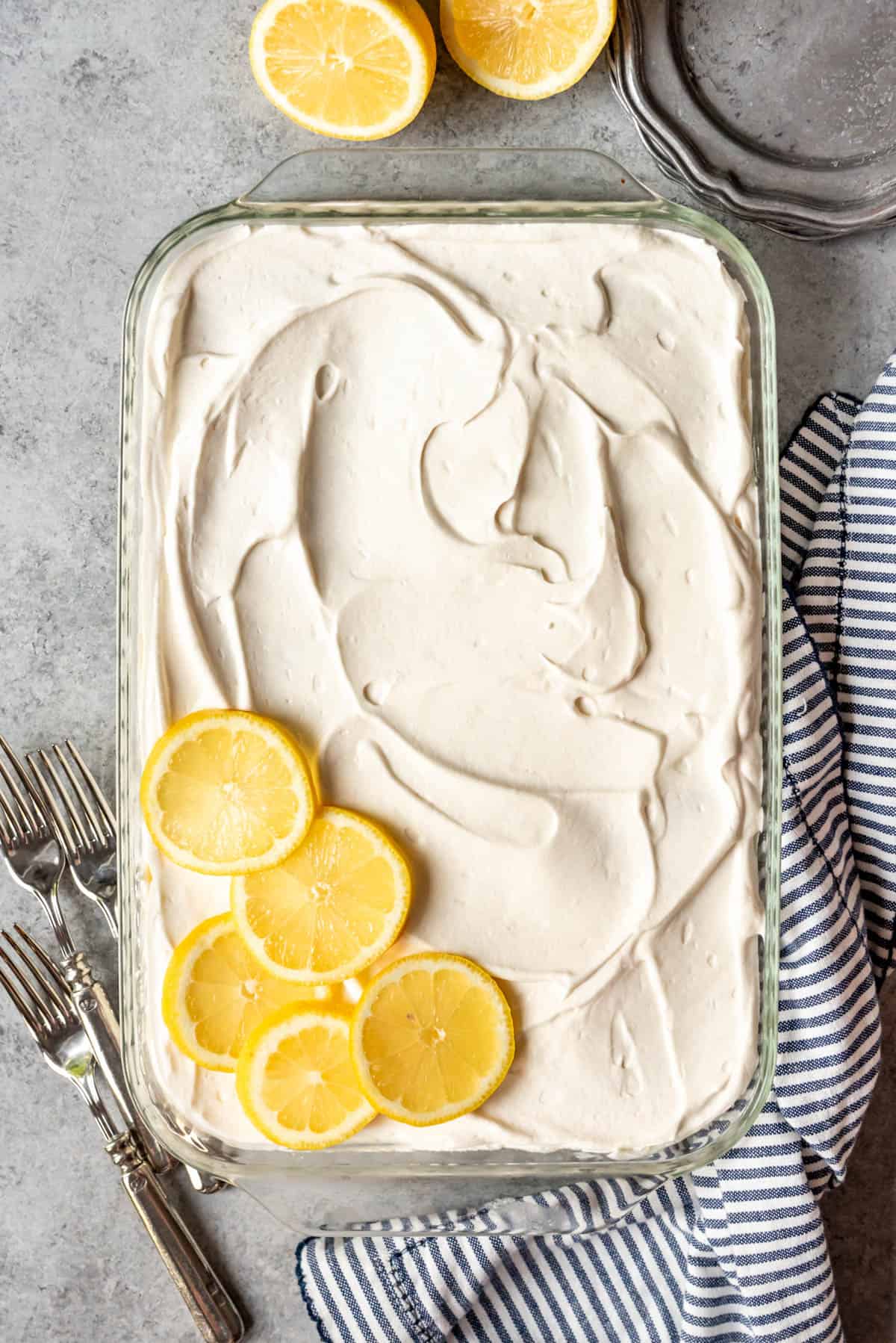 An overhead image of a lemon ice box cake decorated with lemon slices.