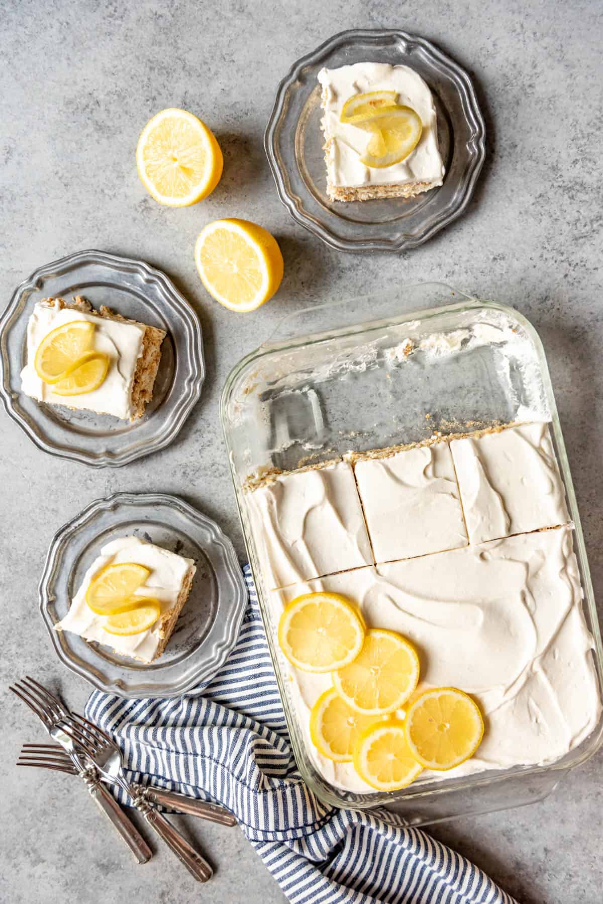 An image of of a lemon icebox cake, sliced into squares and served on dessert plates.