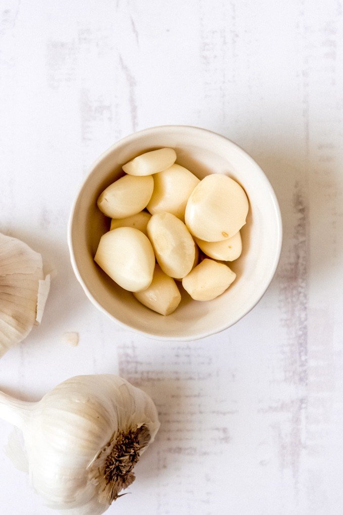 An image of peeled garlic cloves in a bowl.