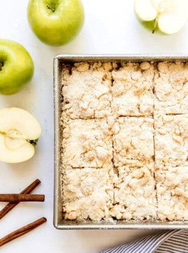 An image of a pan of German apple cake cut into squares.