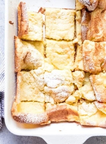 An image of a pan of German pancakes cut into squares.