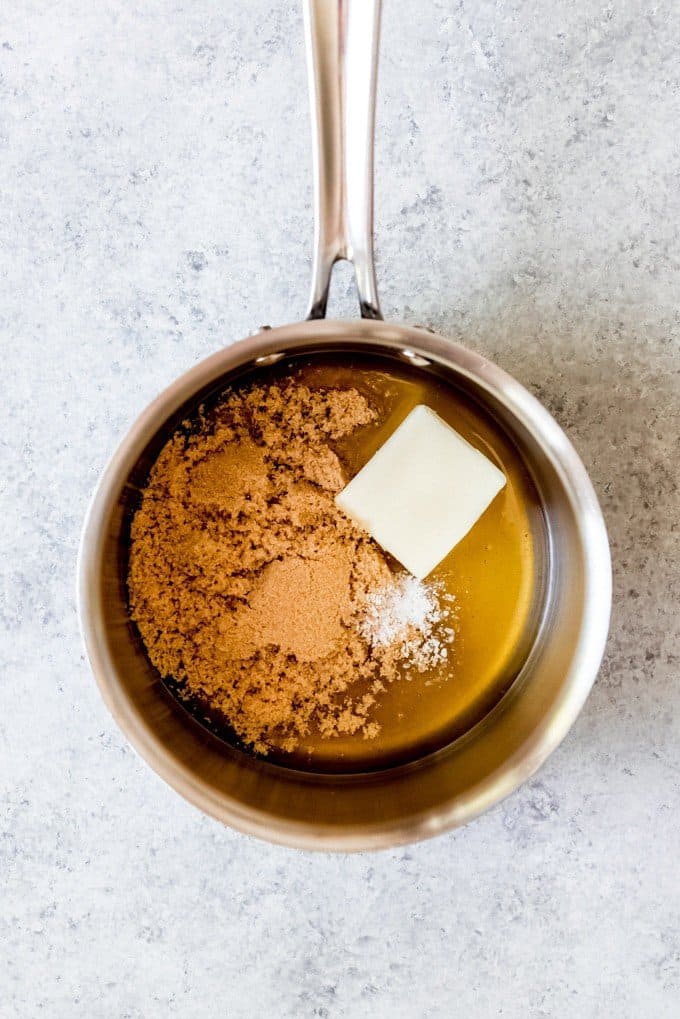 An image of a small saucepan with honey, brown sugar, butter, and salt in it to make the binding agent for homemade granola bars.