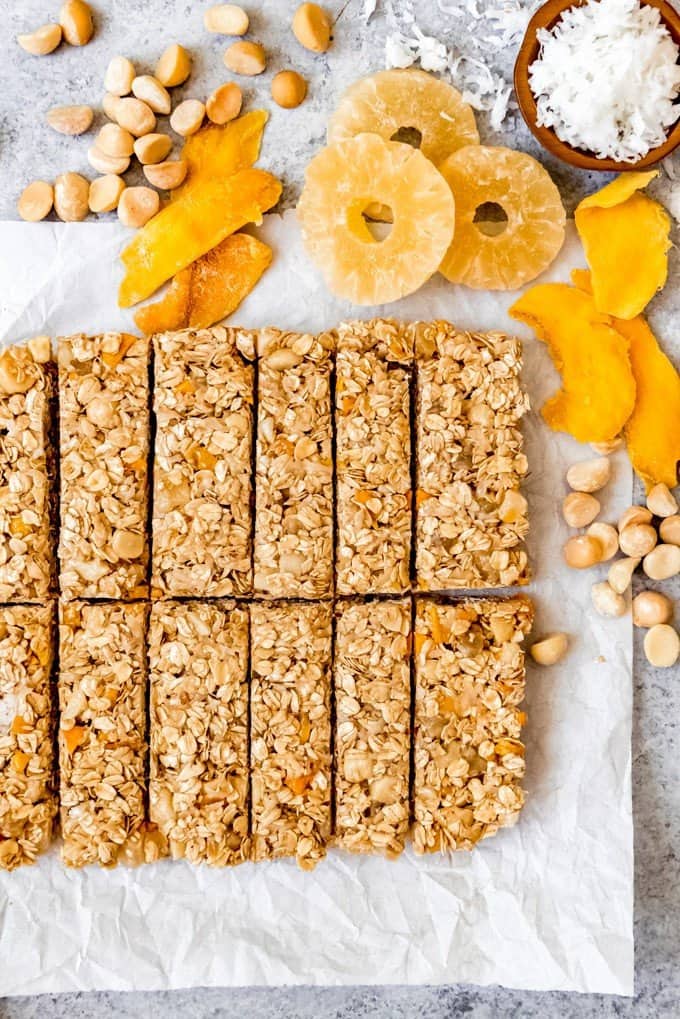 An image of tropical granola bars made with dried mango, dried pineapple, coconut, and macadamia nuts.