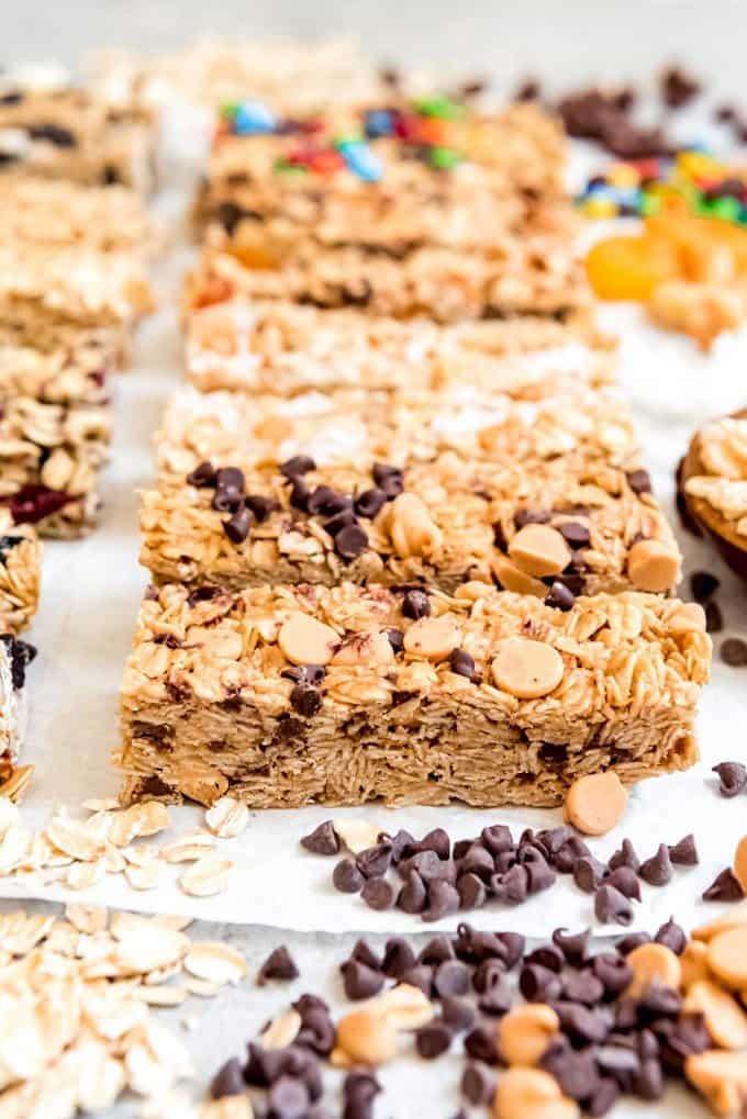 An image of chewy peanut butter granola bars packed with oats, peanut butter chips, and mini chocolate chips.