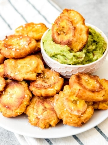 An image of a plate of crispy, salted tostones or patacones made with fried green plantains.