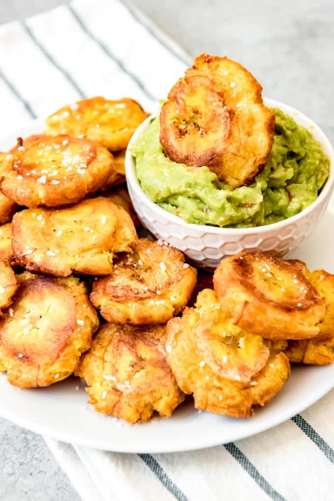 An image of a plate of crispy, salted tostones or patacones made with fried green plantains.