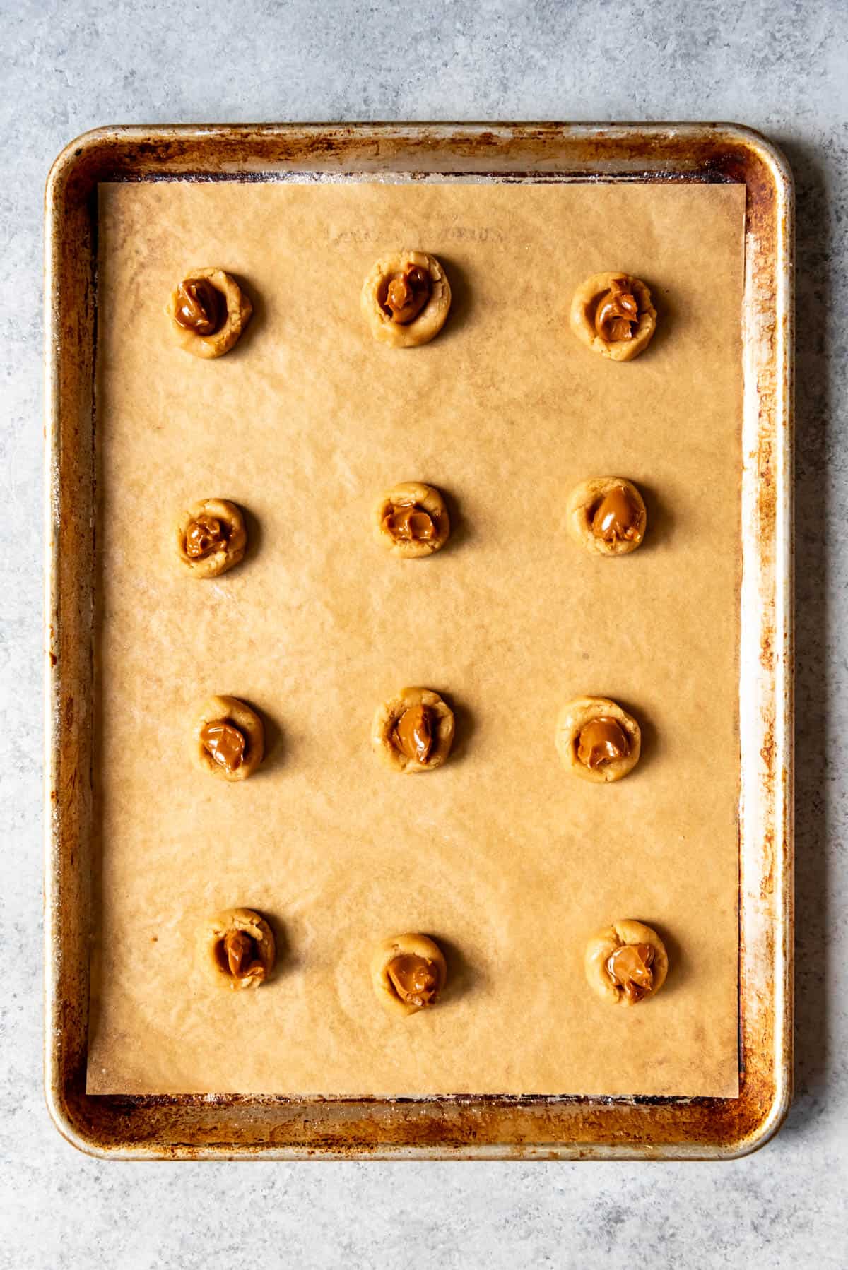 An overhead image of balls of cookie dough stuffed with dulce de leche.