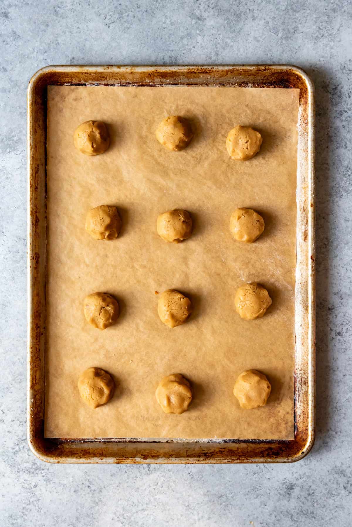 Balls of cookie dough on a baking sheet.