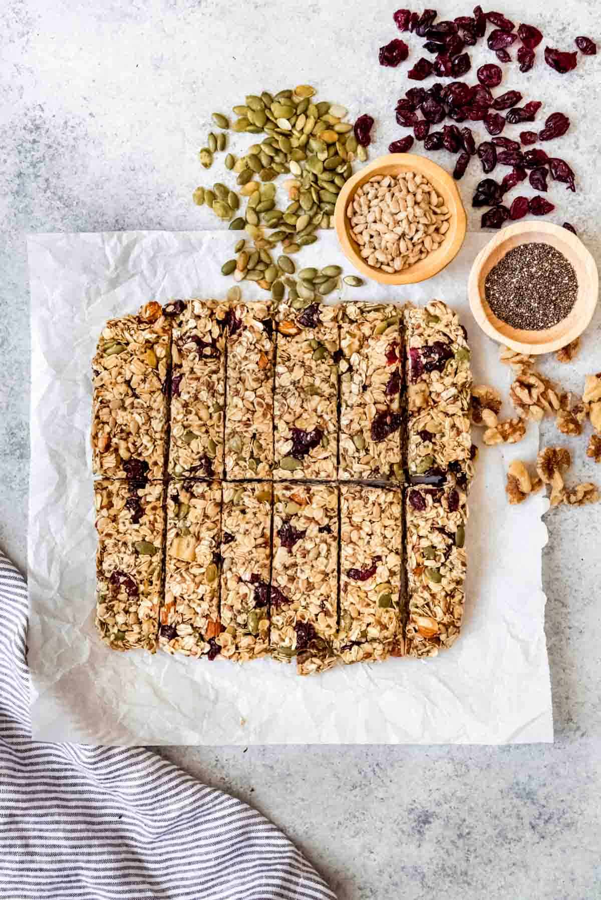 An image of a chewy homemade granola bar made with lots of fruit, seeds, and nuts, including chia, pumpkin, and sunflower seeds.