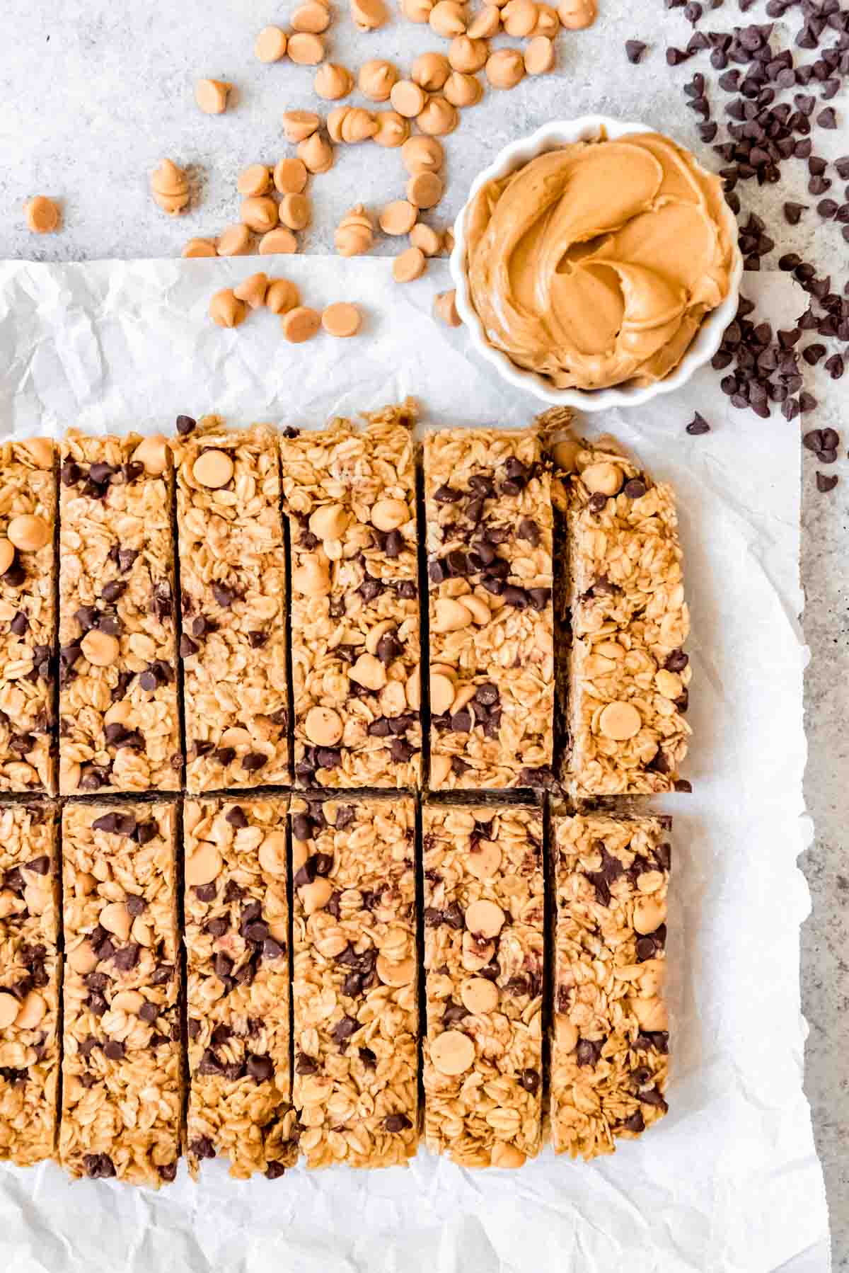 An image of homemade chewy peanut butter granola bars with mini chocolate chips.