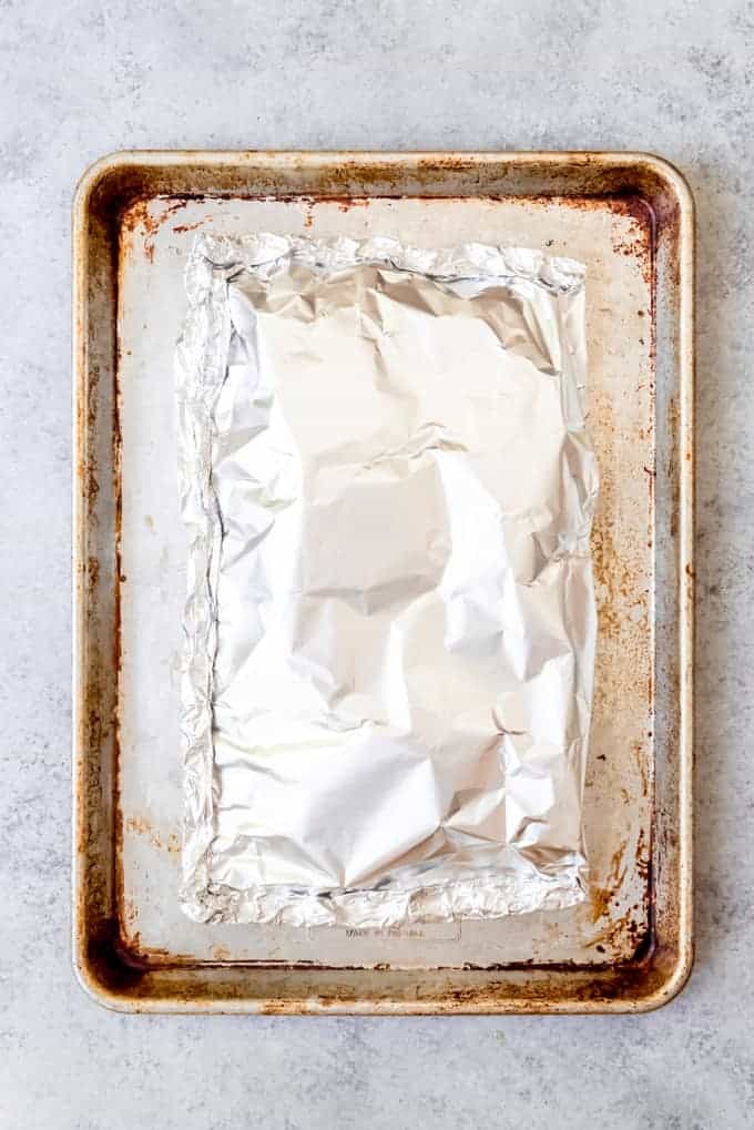 An image of a foil pouch on a baking sheet to bake whole fish in the oven.