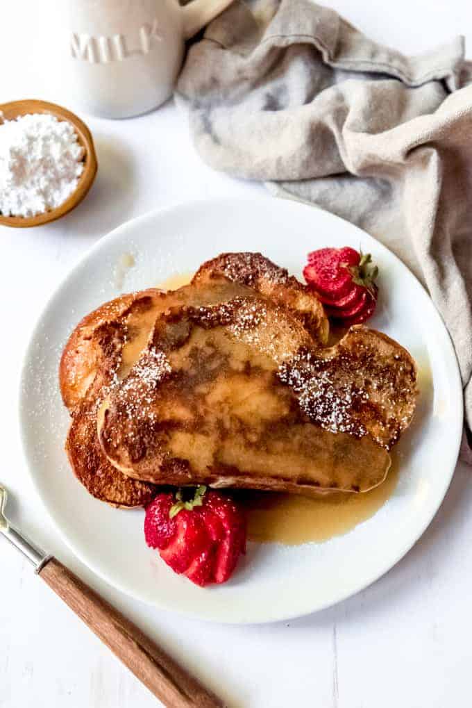 An image of classic cinnamon french toast with buttermilk caramel syrup on top.