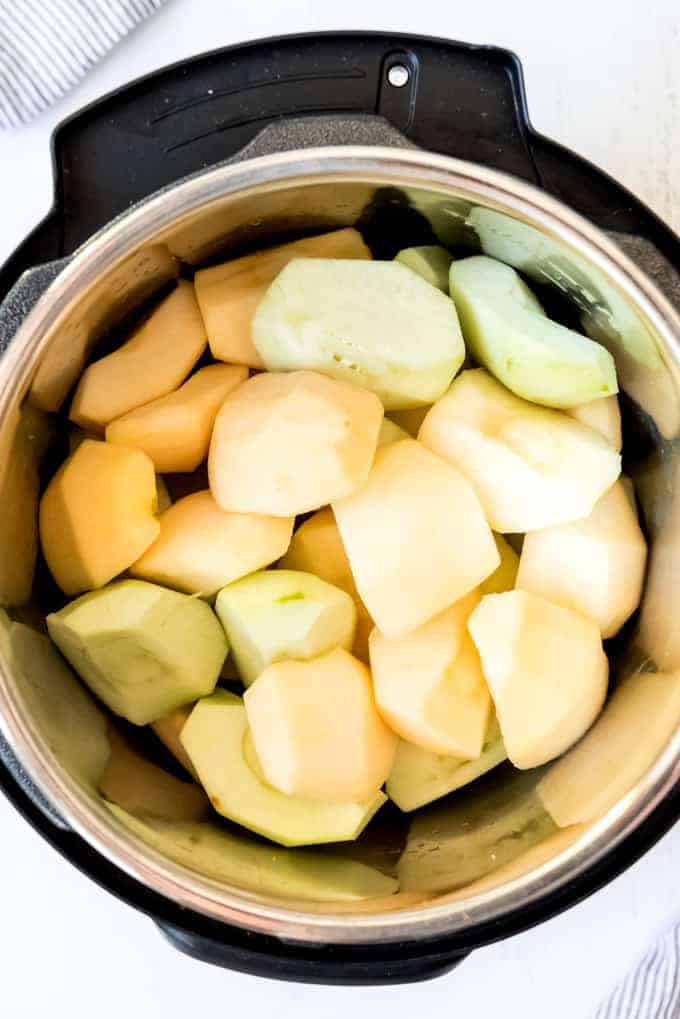An image of peeled and cored apples in the instant pot.