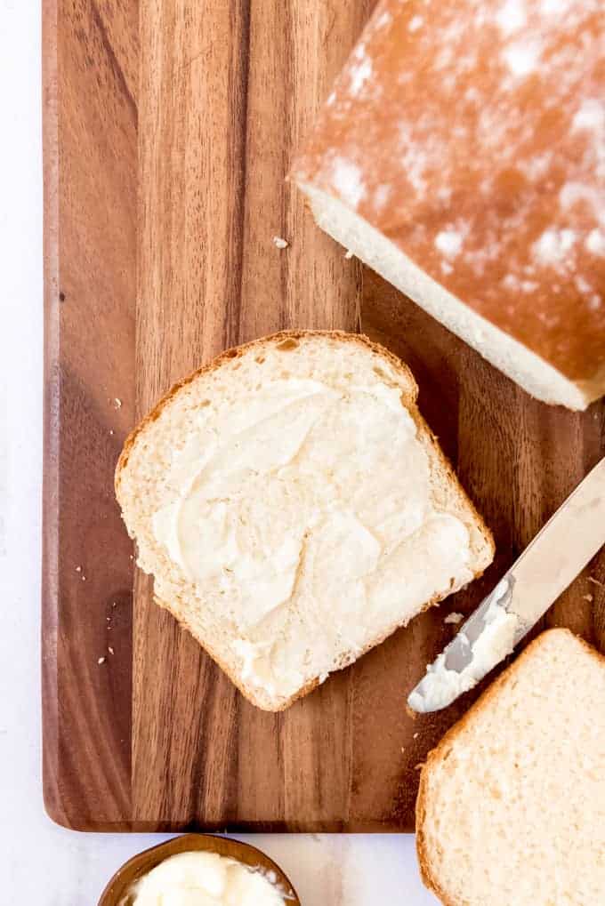 An image of a buttered slice of fresh homemade bread made with leftover mashed potatoes.