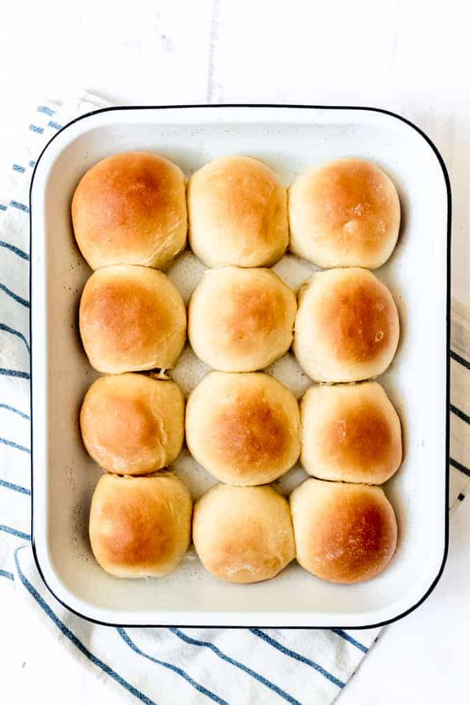 An image of golden brown homemade rolls in a pan.