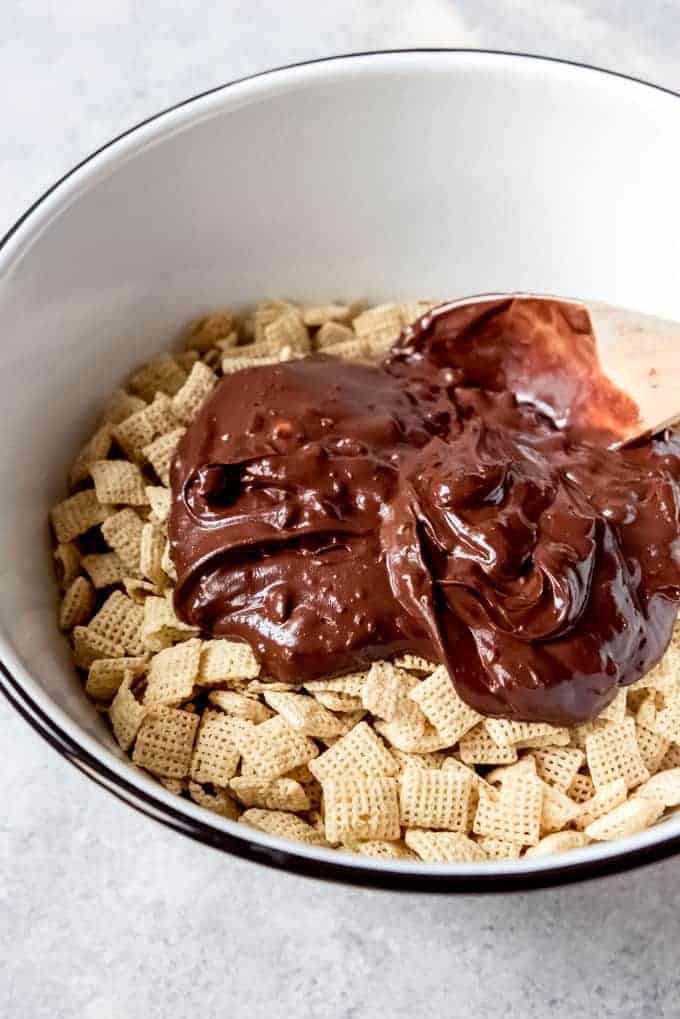 An image of melted chocolate and peanut butter poured over rice Chex cereal.
