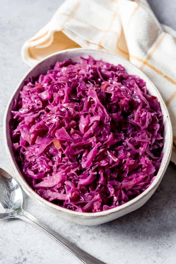 An image of a serving bowl filled with German red cabbage, also known as blaukraut or rotkohl.