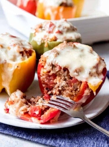 An image of a red stuffed bell pepper that is cut in half.