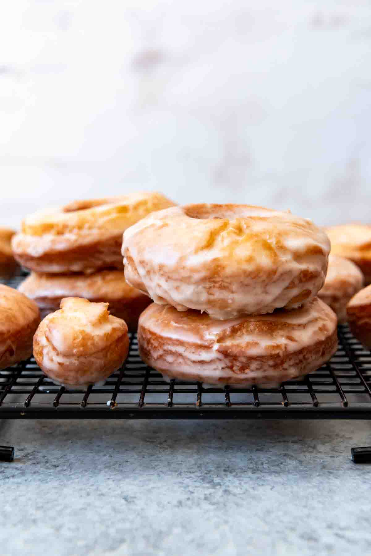 An image of glazed old-fashioned donuts stacked on top of each other.