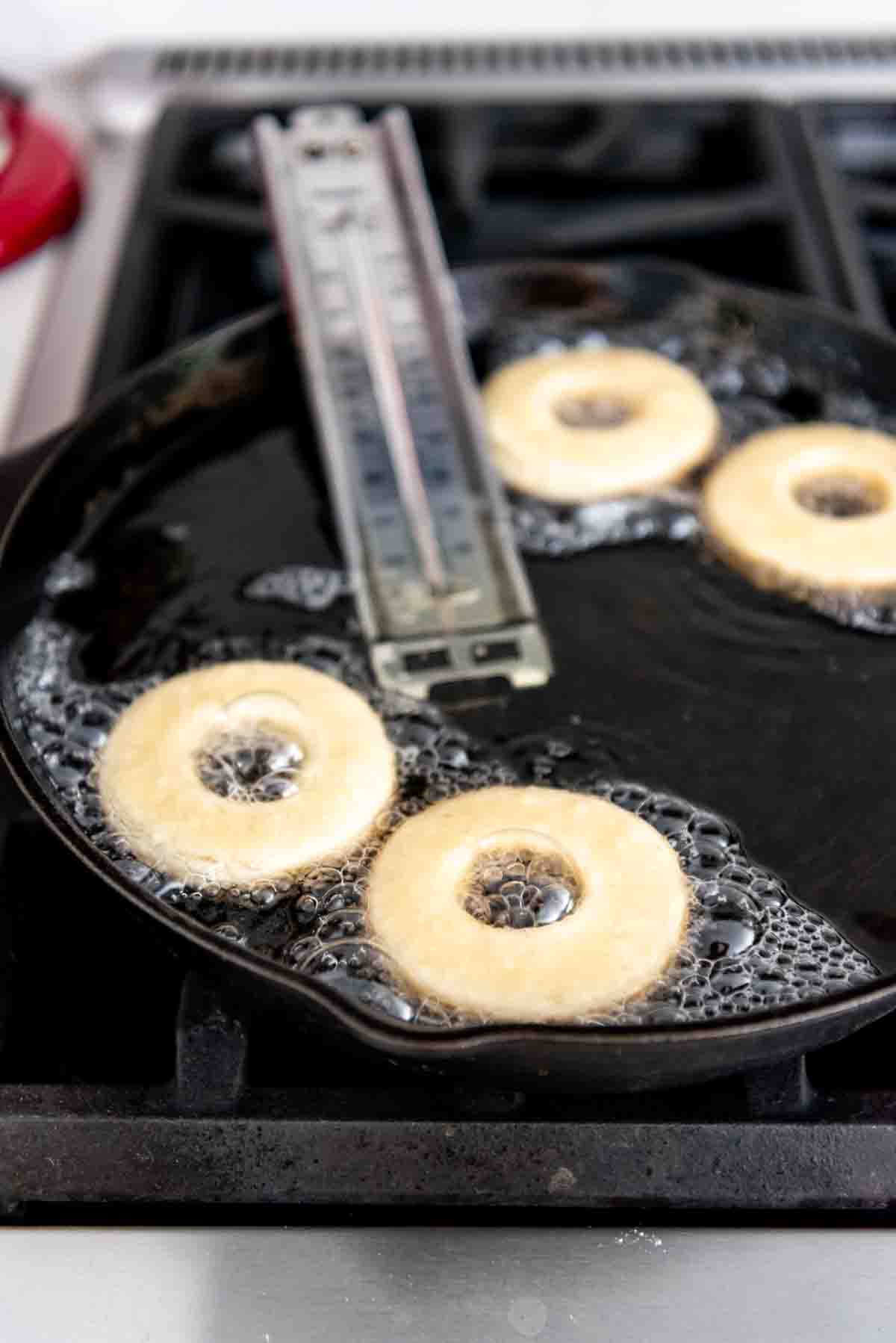 Frying doughnuts in hot oil.