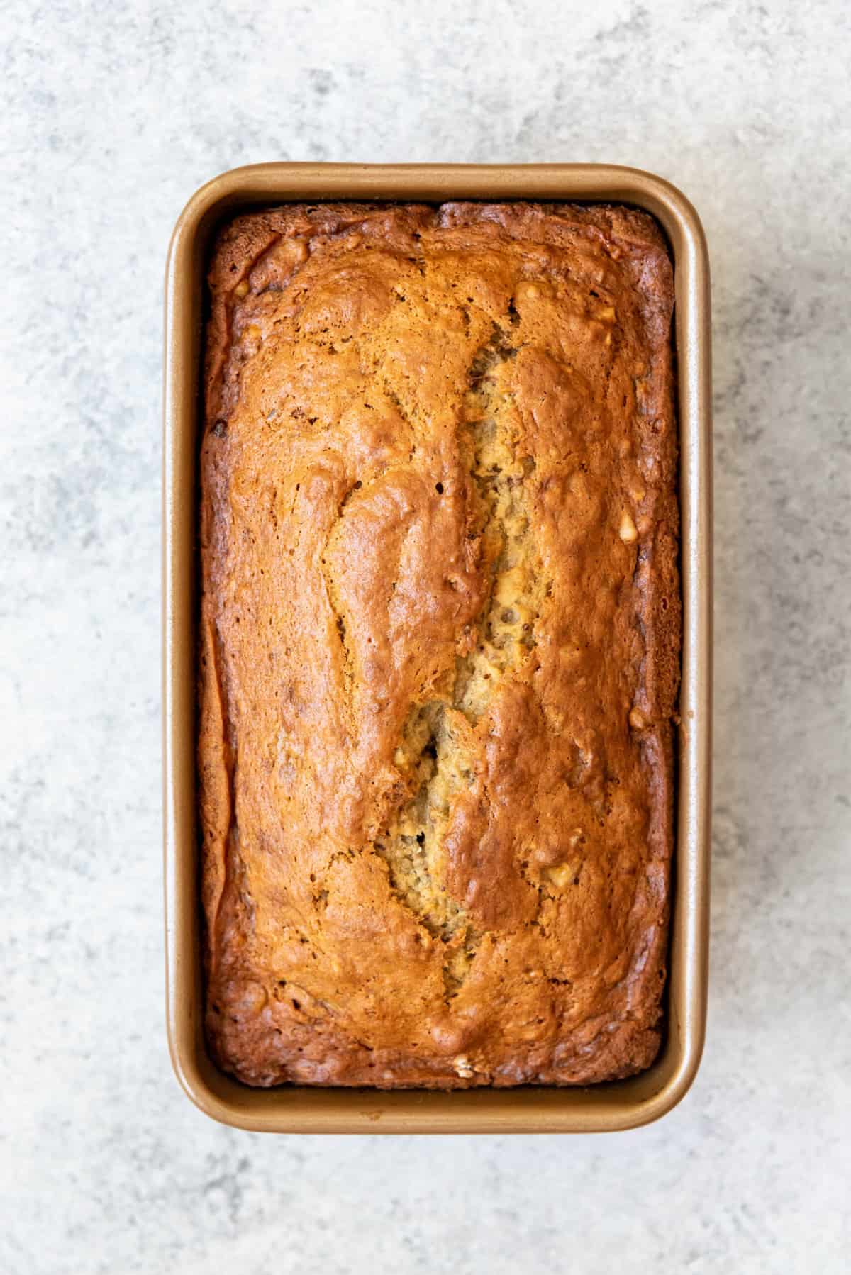 An image of fresh baked banana bread in a loaf pan.
