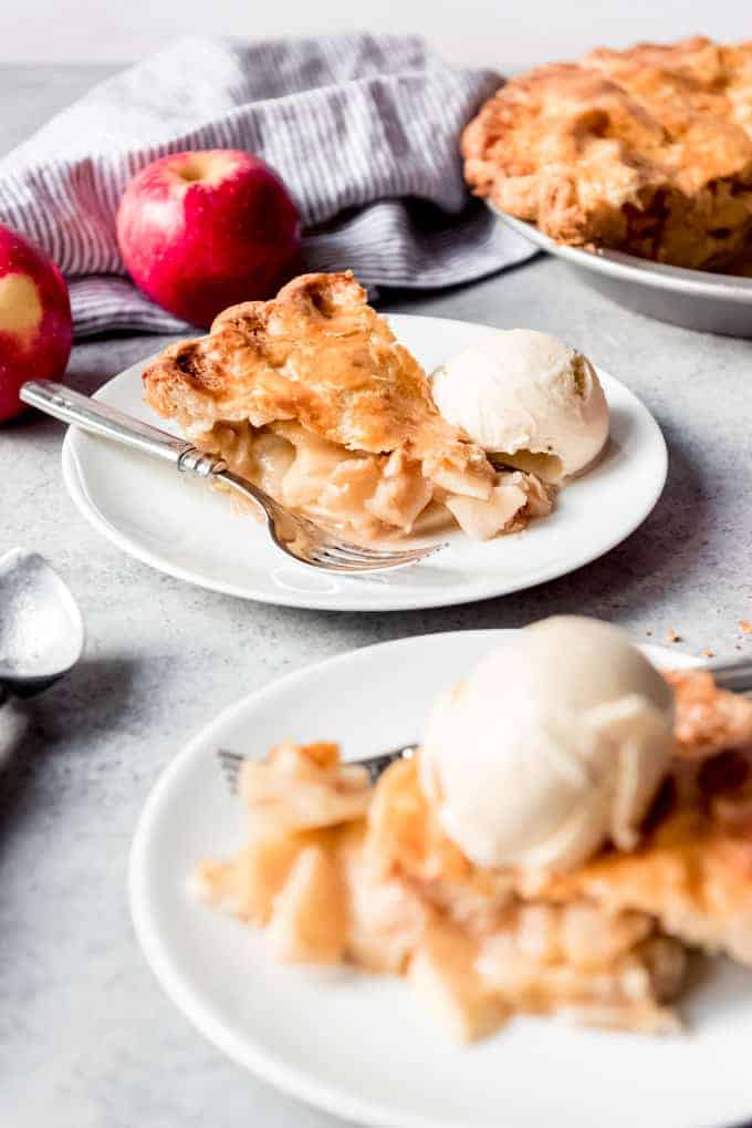 An image of slices of apple pie a la mode with vanilla ice cream.
