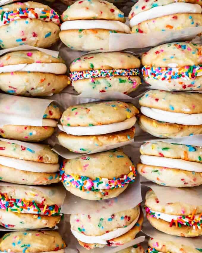 An image of sprinkle whoopie pies stacked with squares of wax paper between them.