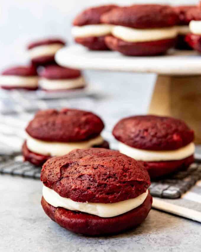 An image of soft red velvet cookies sandwiched with cream cheese frosting.