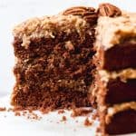 An image of a sliced, three-layer German chocolate cake with homemade coconut pecan frosting.