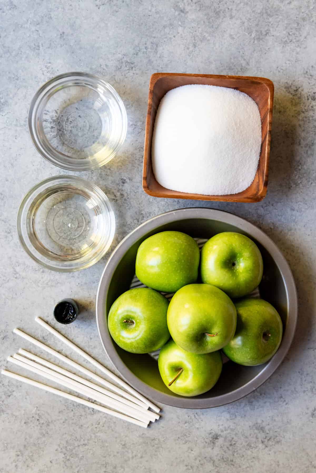 An image of the ingredients and supplied needed for making candied apples.