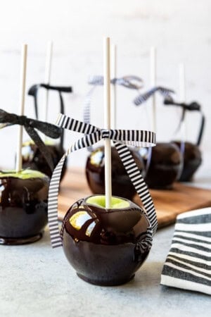 An image of poison apples with bows tied around the sticks.