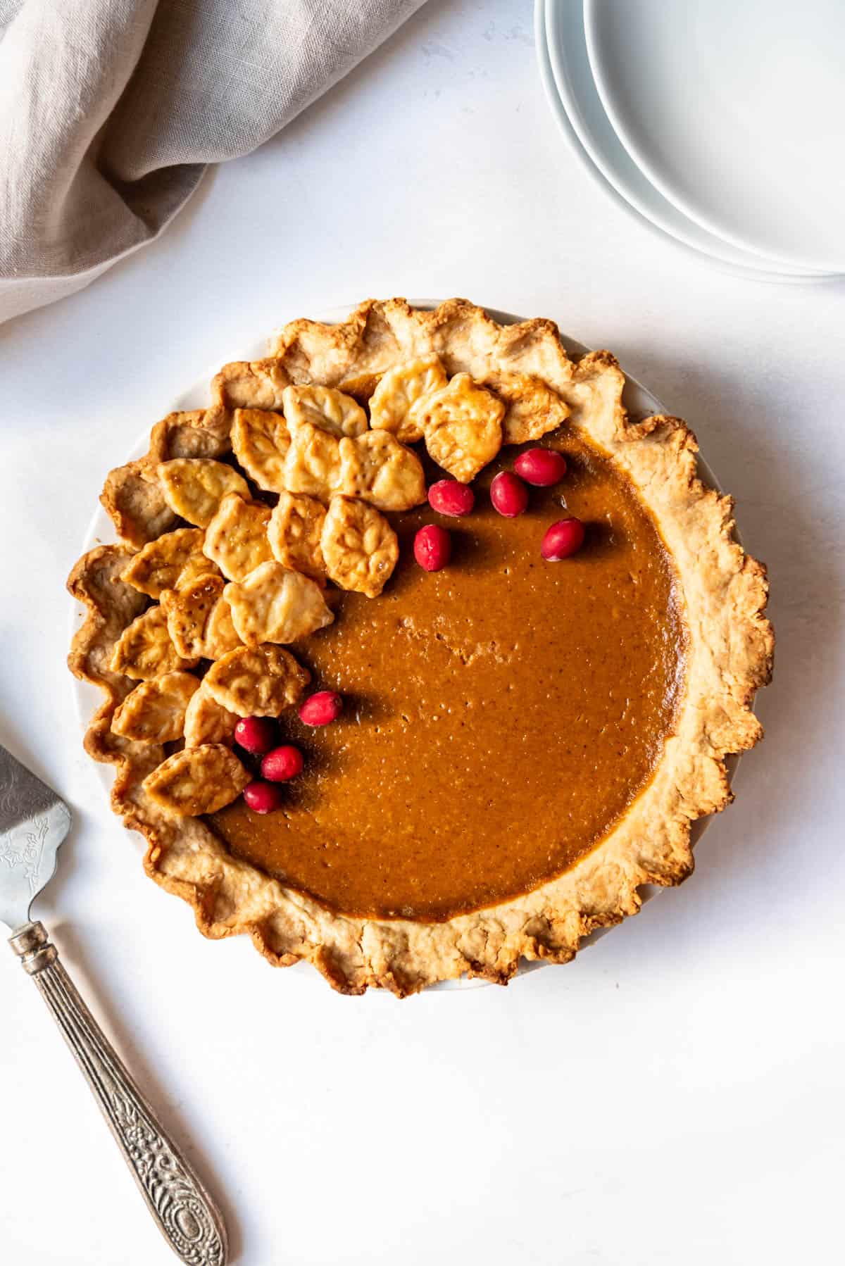 A fully baked and decorated pumpkin pie.