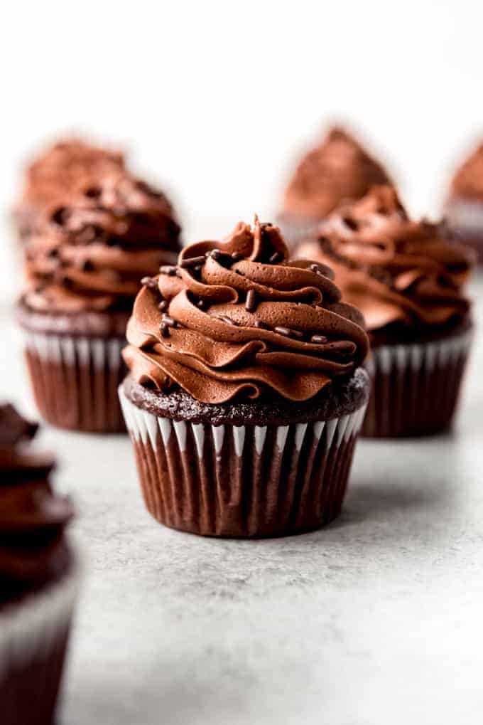 An image of chocolate cupcakes with chocolate frosting.