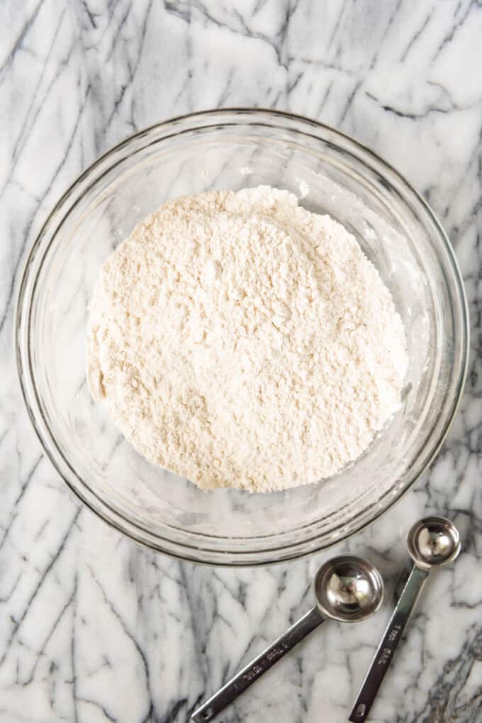 Flour and salt in a glass mixing bowl.