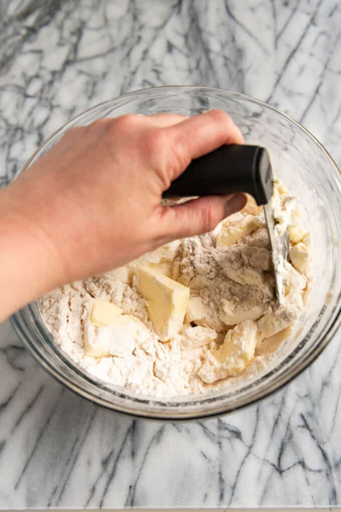 An image of a pastry cutter cutting fat into flour until the butter is the size of peas for making pie crust.