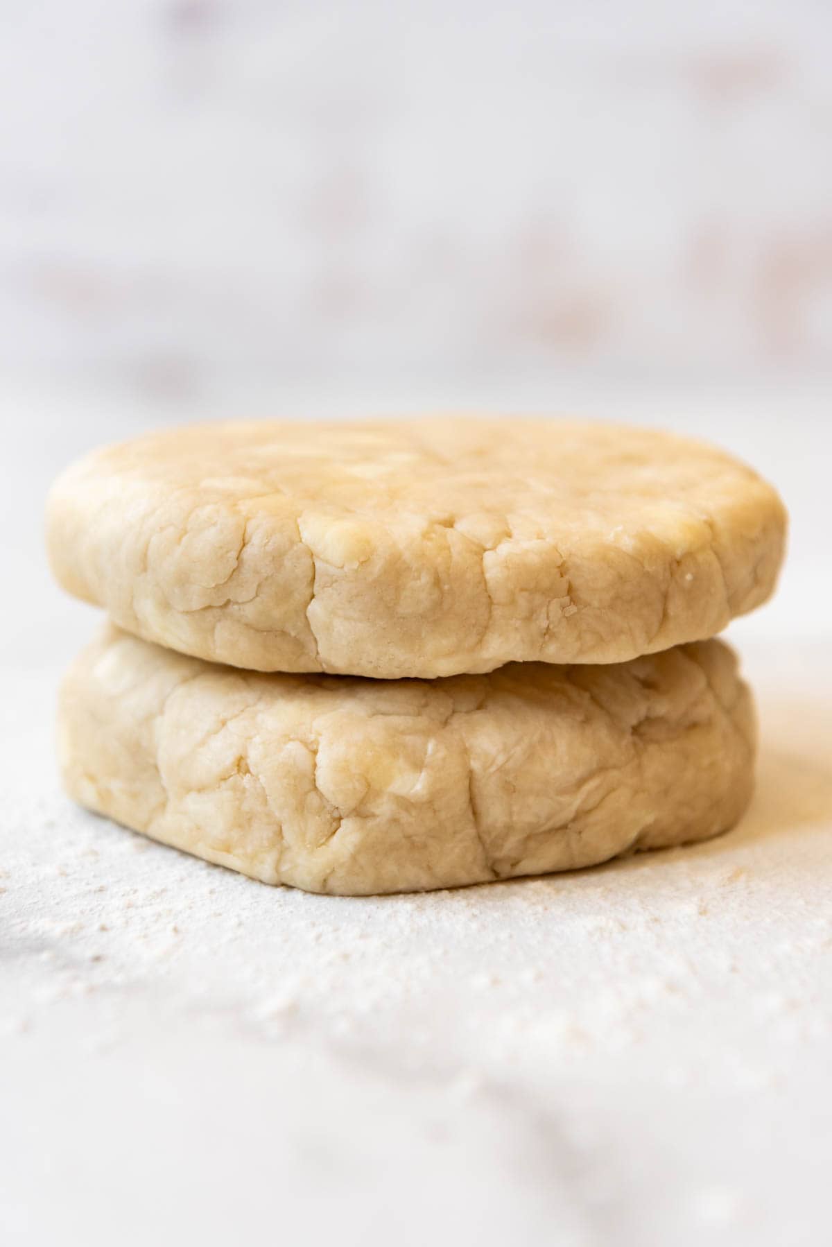 Two discs of pie crust that have been unwrapped.