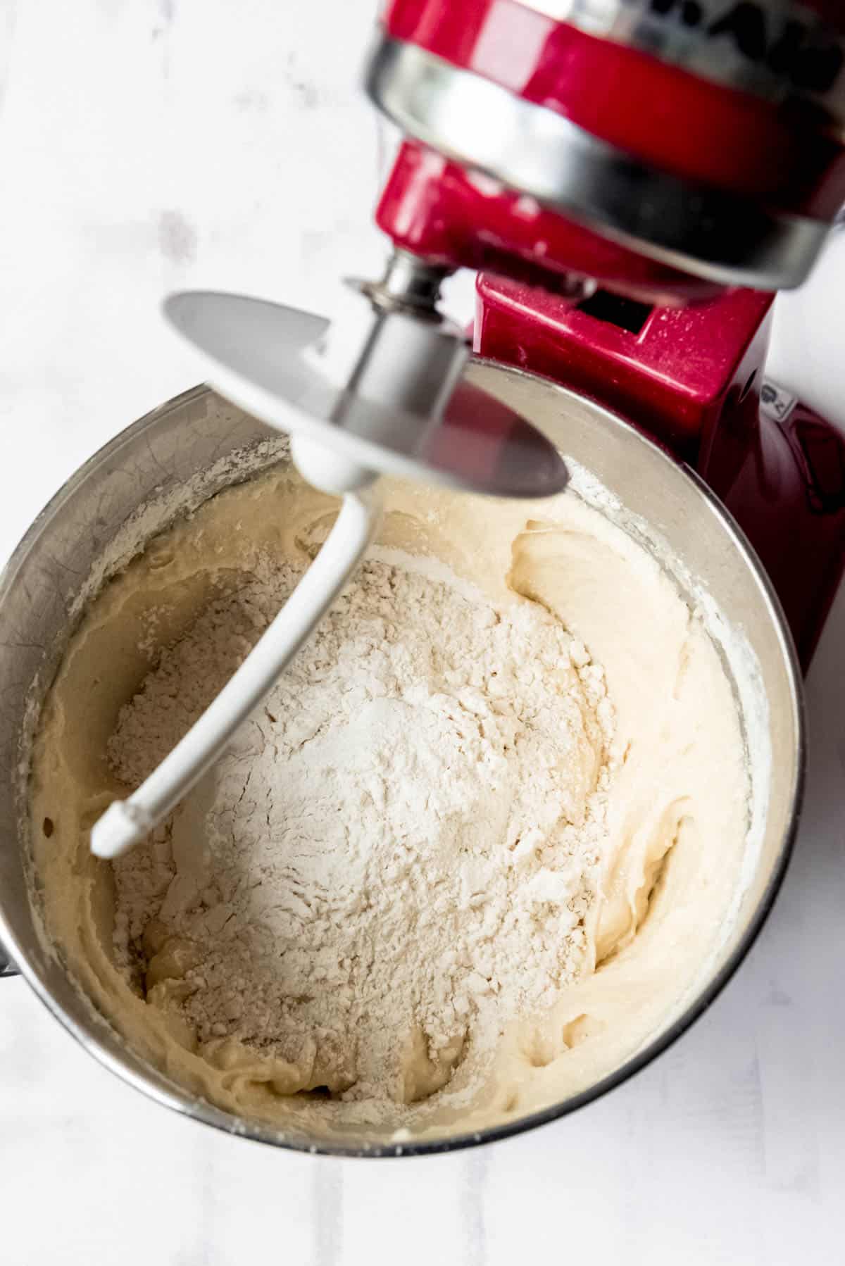 Adding flour to make a yeast dough.