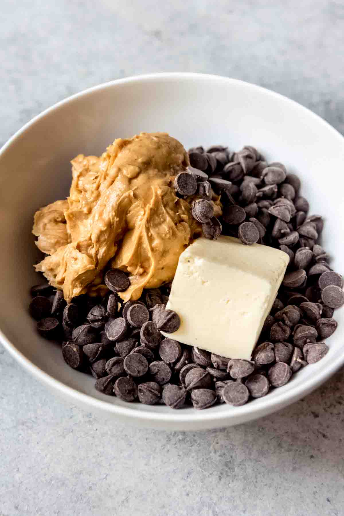 An image of peanut butter, chocolate, and butter in a bowl.