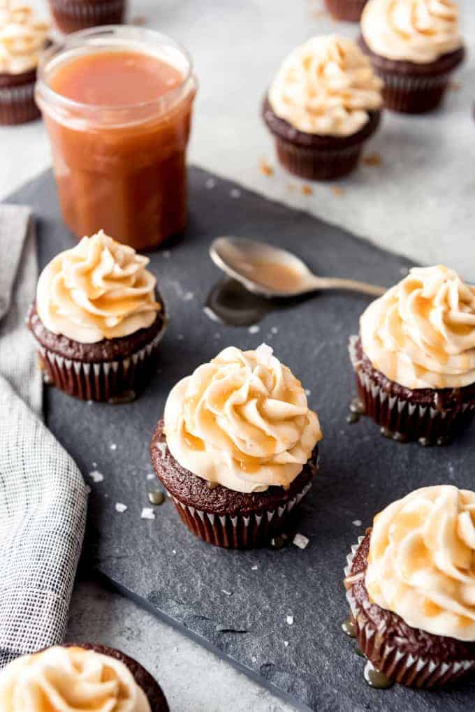 Another image of cupcakes with caramel drizzled over the top of a salted caramel buttercream frosting.