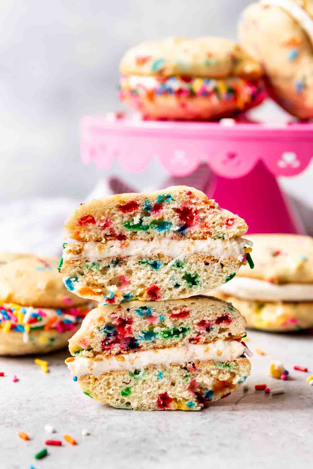 An image of a cross-section of a funfetti whoopie pie that has been cut in half to show the sprinkle interior.