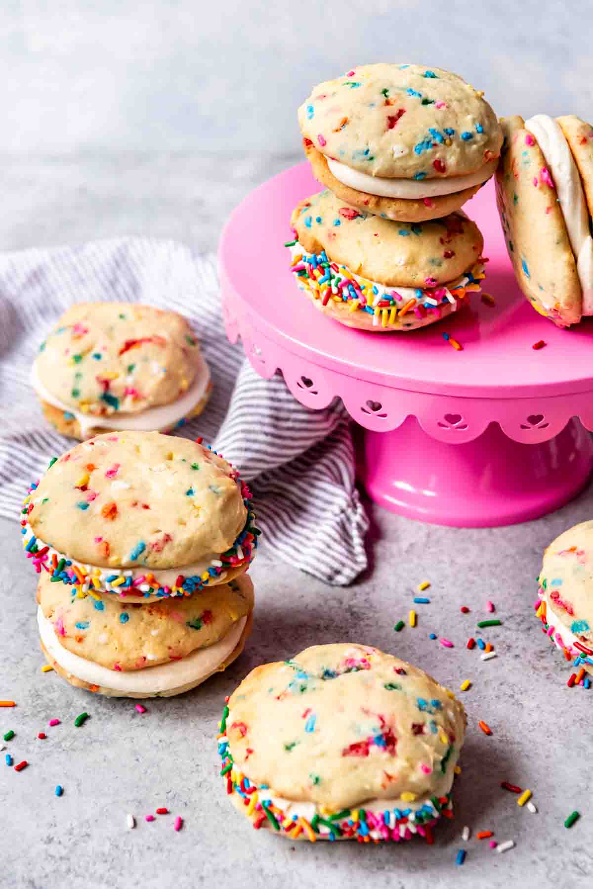 An image of confetti whoopie pies stacked on a pink cake stand.