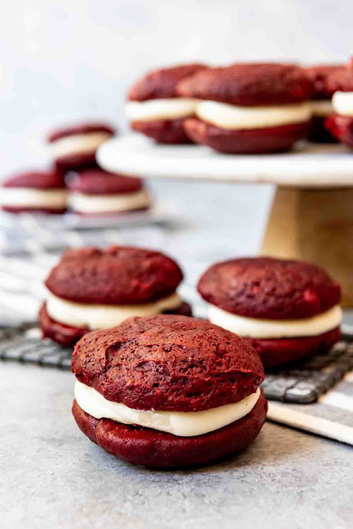 An image of soft red velvet cookies sandwiched with cream cheese frosting.