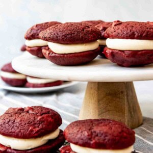 An image of soft red velvet cookies sandwiched with cream cheese frosting.